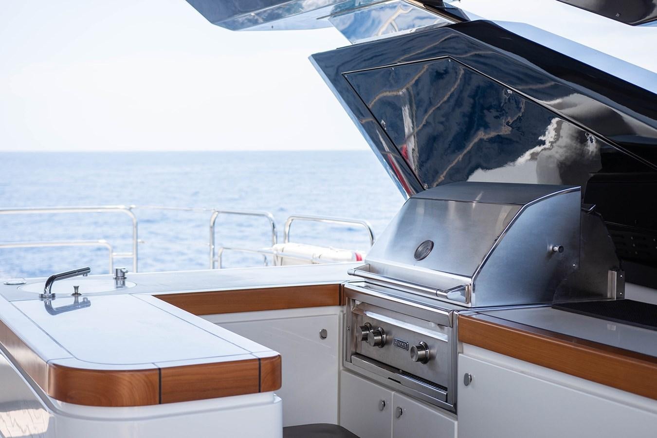 a boat with a sink and a large boat in the background aboard GV Yacht for Sale