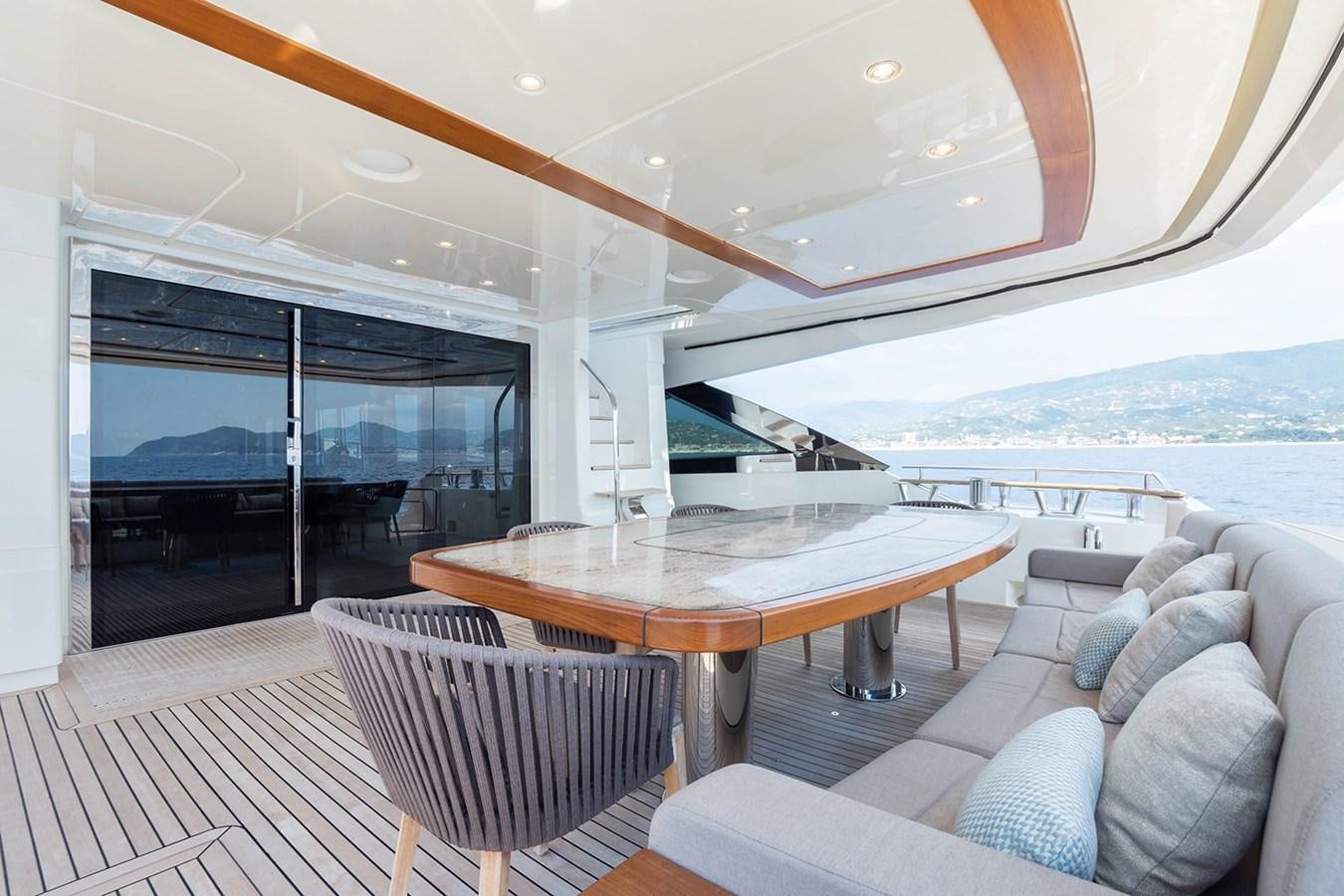 a large living room with a large table and chairs aboard GV Yacht for Sale