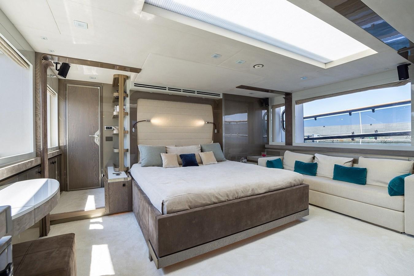 a room with a bed and a large window aboard GV Yacht for Sale