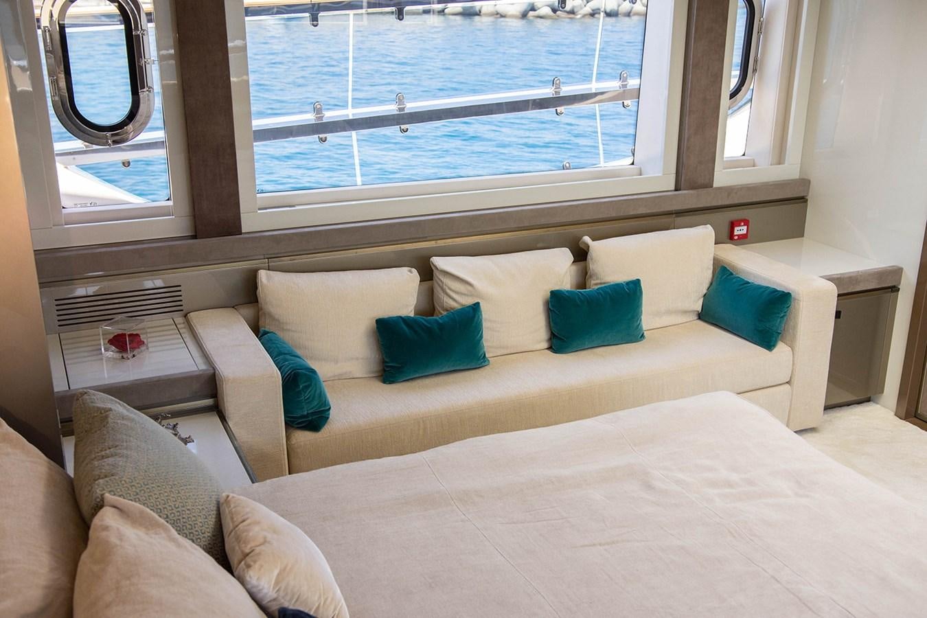 a couch with pillows on it aboard GV Yacht for Sale