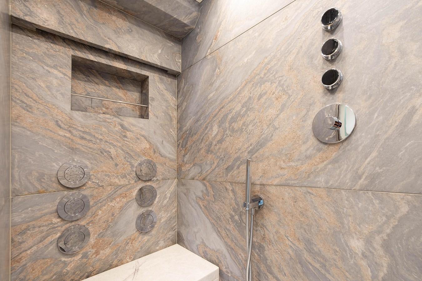 a tile wall with a round light aboard GV Yacht for Sale