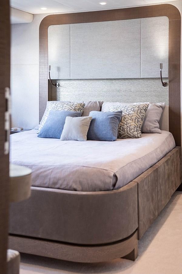a bed with a white sheet aboard GV Yacht for Sale