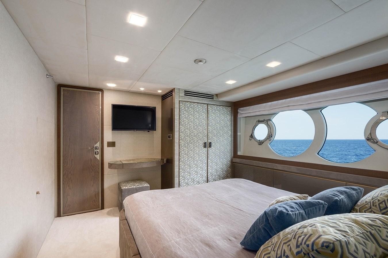 a bedroom with a bed and a television aboard GV Yacht for Sale