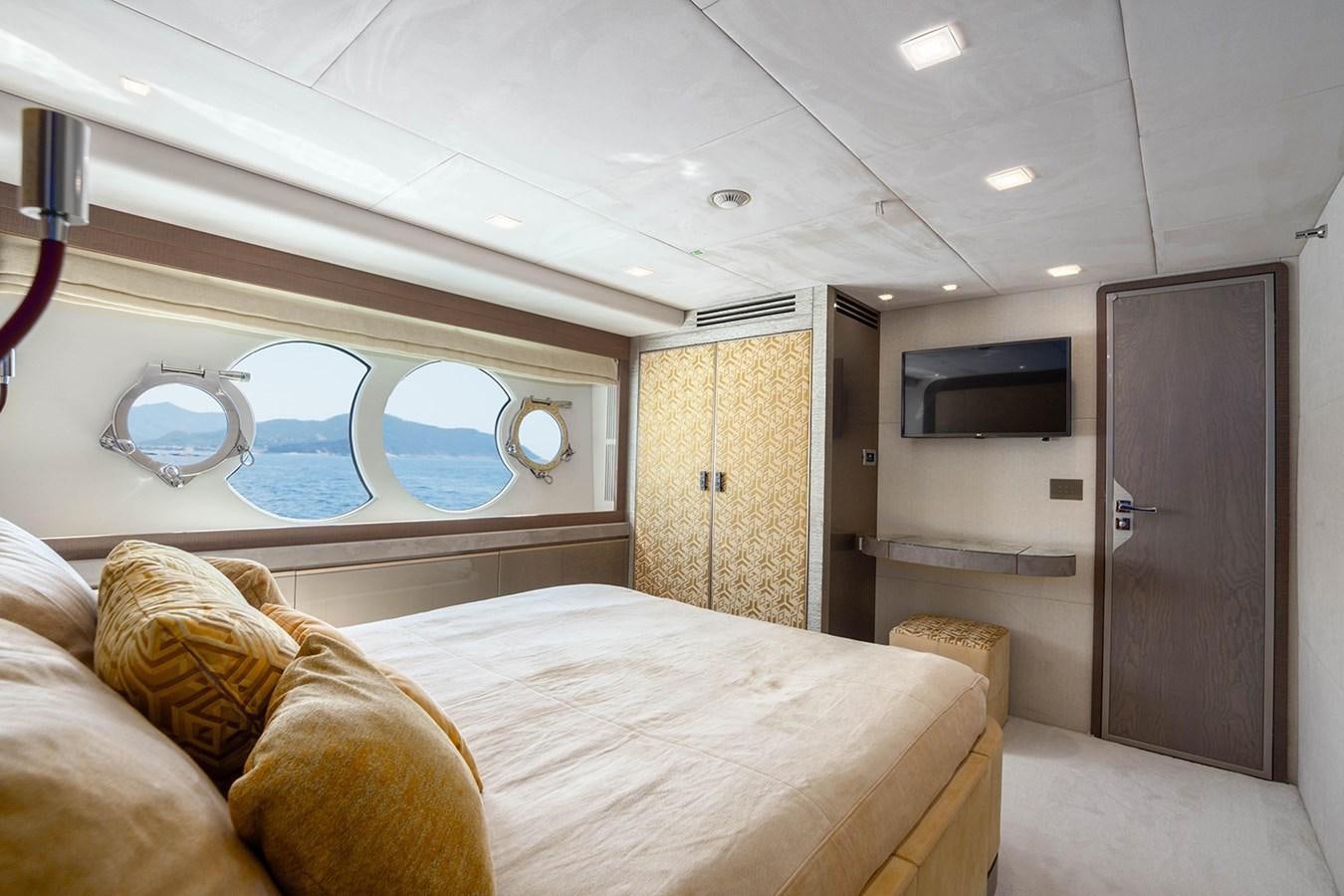 a room with a bed and a television aboard GV Yacht for Sale