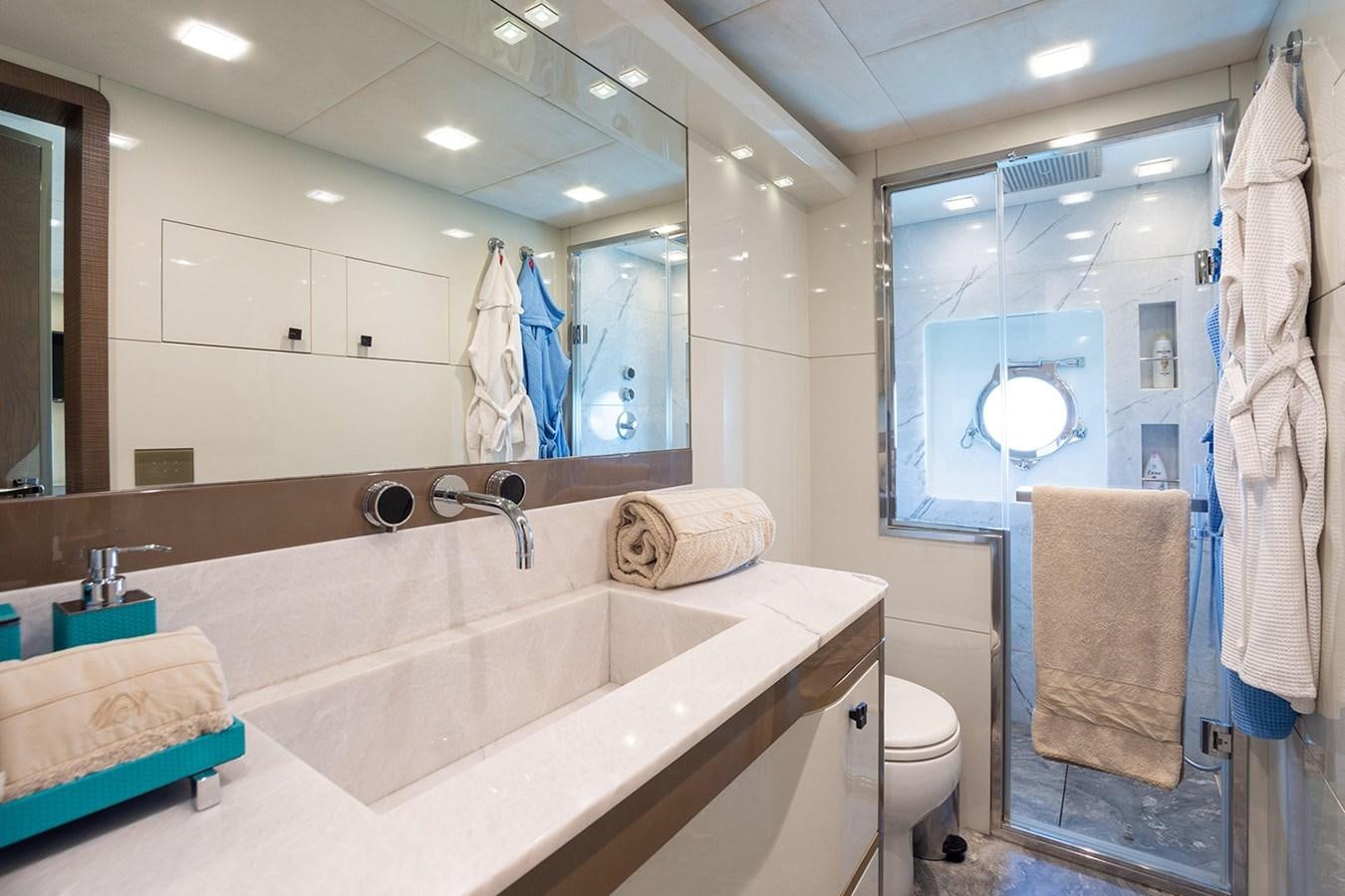 a bathroom with a large mirror aboard GV Yacht for Sale