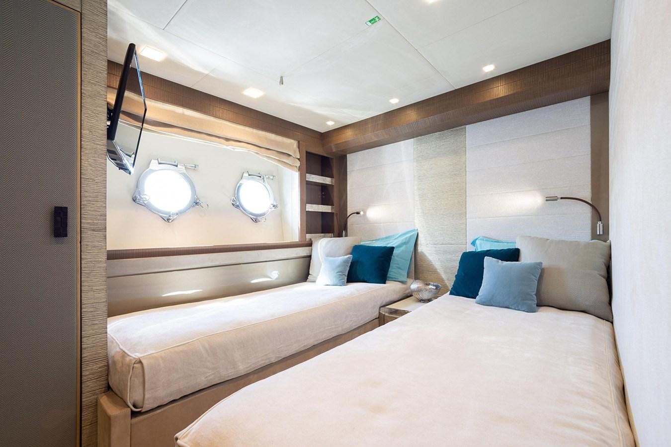 a room with a bed and a mirror aboard GV Yacht for Sale