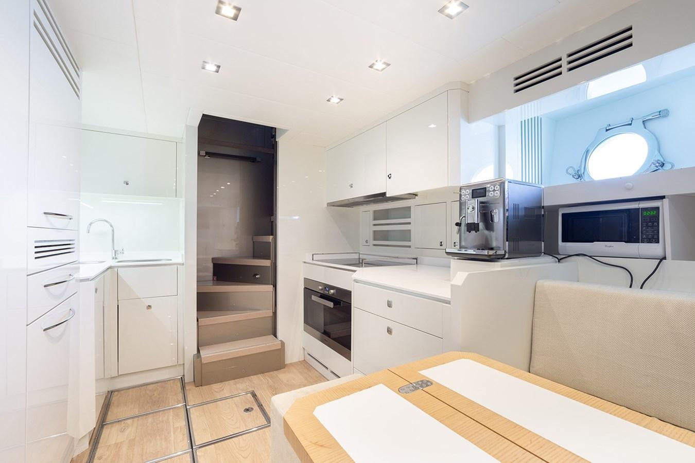 a kitchen with white cabinets aboard GV Yacht for Sale