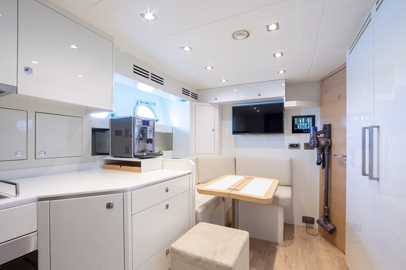 a kitchen with white cabinets aboard GV Yacht for Sale