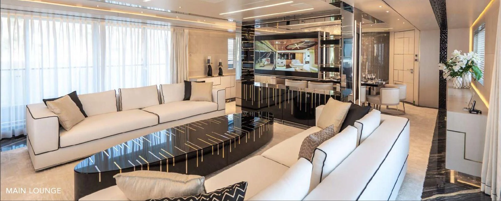 a living room with a large glass coffee table aboard MOONRAKER Yacht for Sale