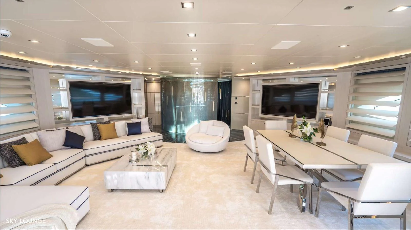 a living room with a table and couches aboard MOONRAKER Yacht for Sale