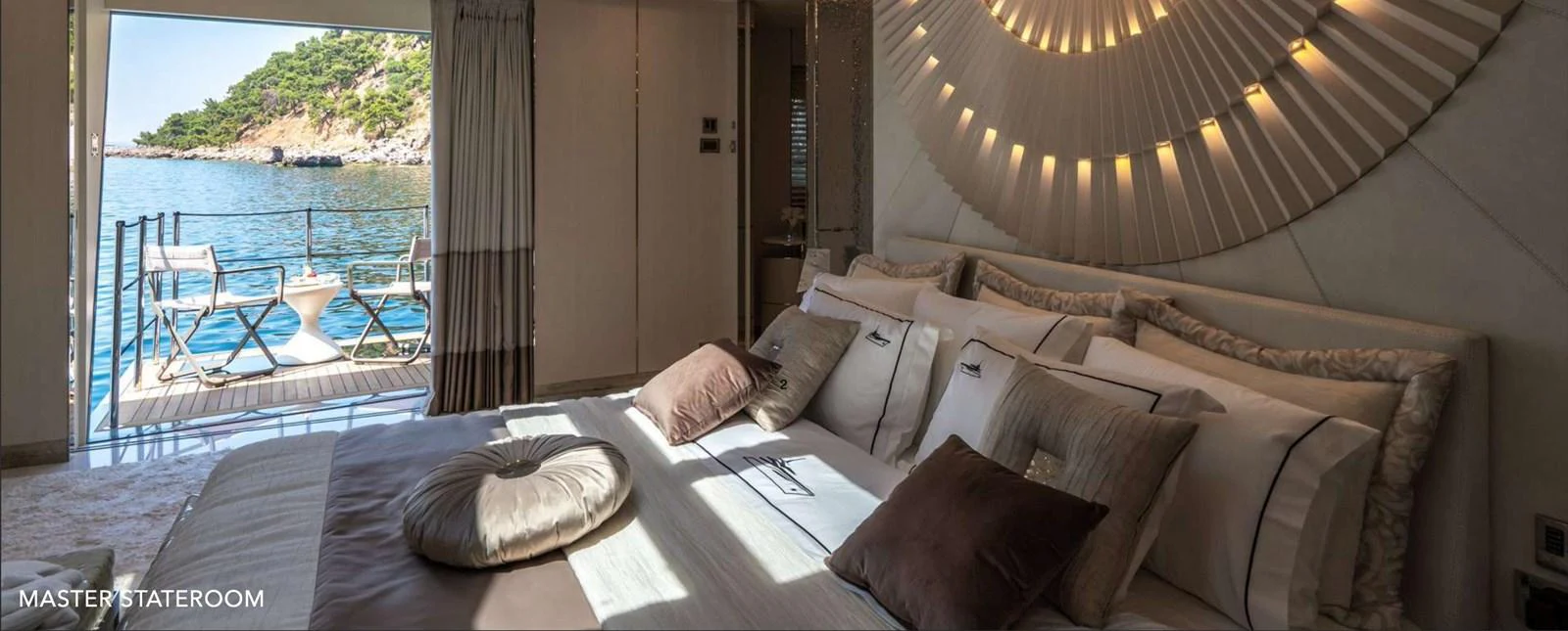a bed with pillows and a table aboard MOONRAKER Yacht for Sale