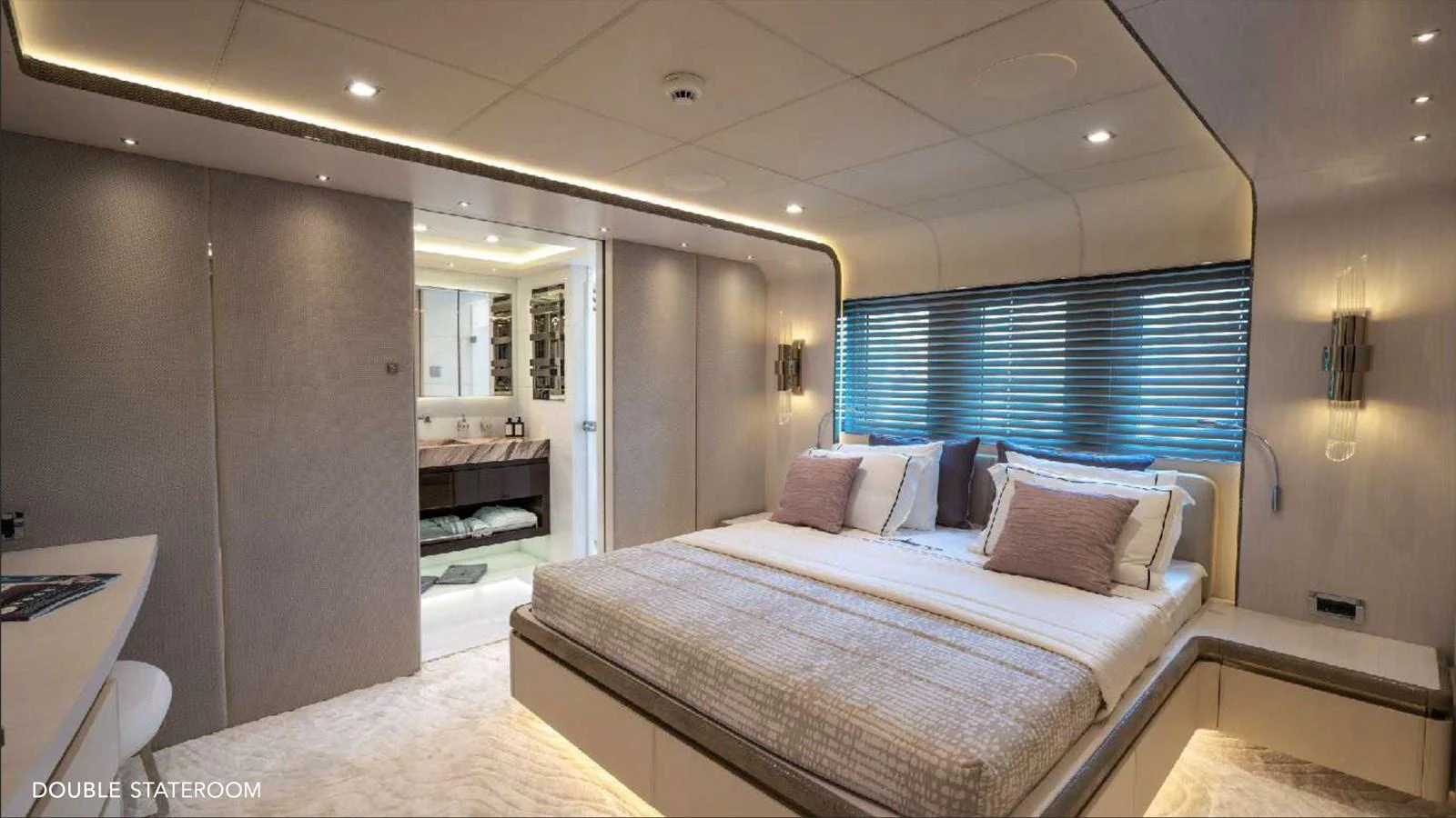 a bedroom with a bed and a mirror aboard MOONRAKER Yacht for Sale