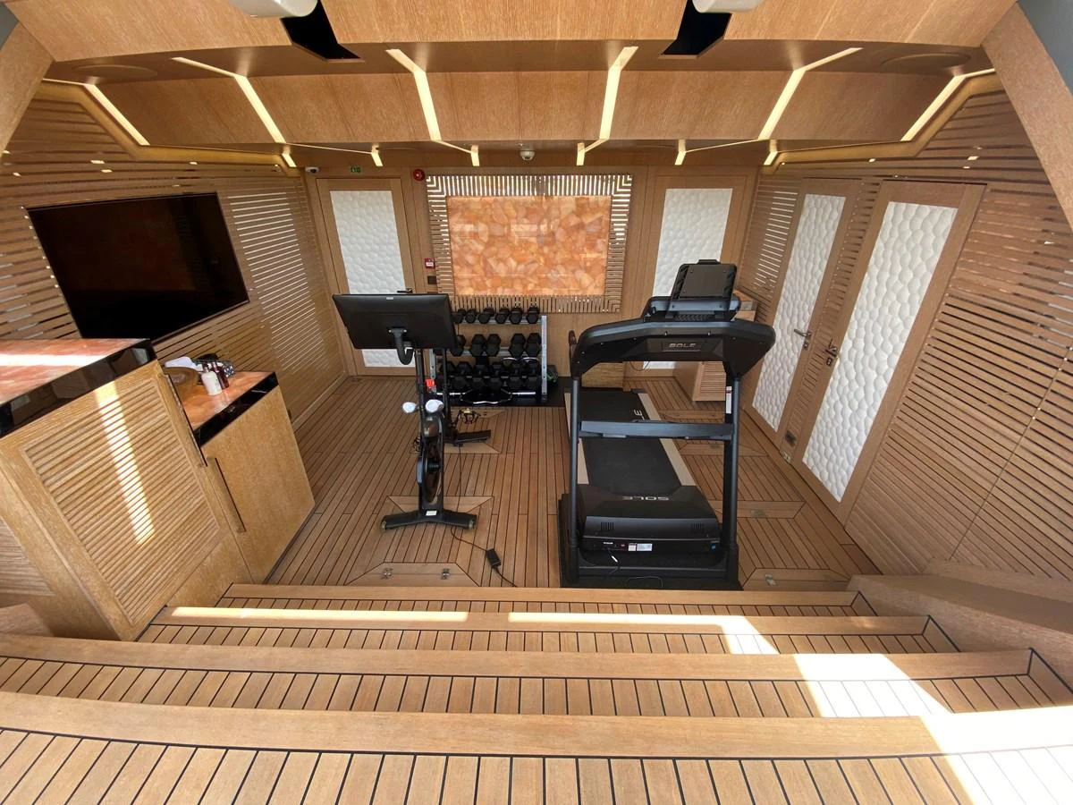 a room with a piano and a tv aboard MOONRAKER Yacht for Sale