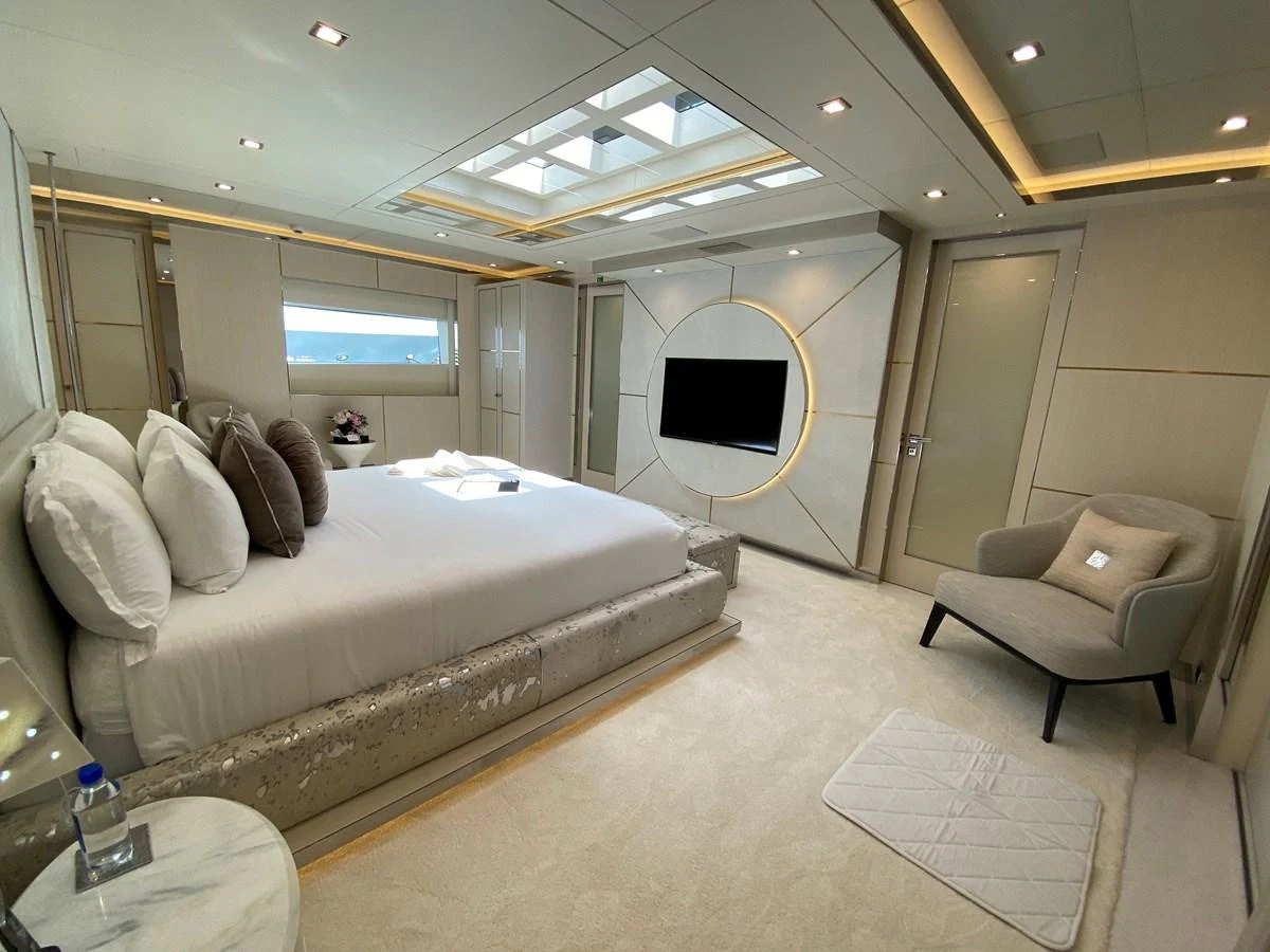 a room with a bed and a couch aboard MOONRAKER Yacht for Sale