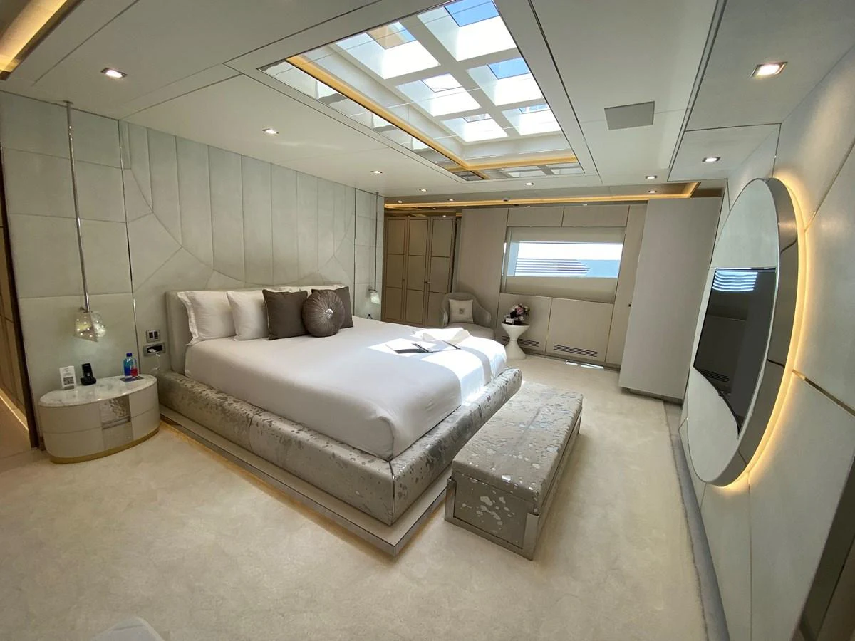 a room with a bed and a large mirror aboard MOONRAKER Yacht for Sale