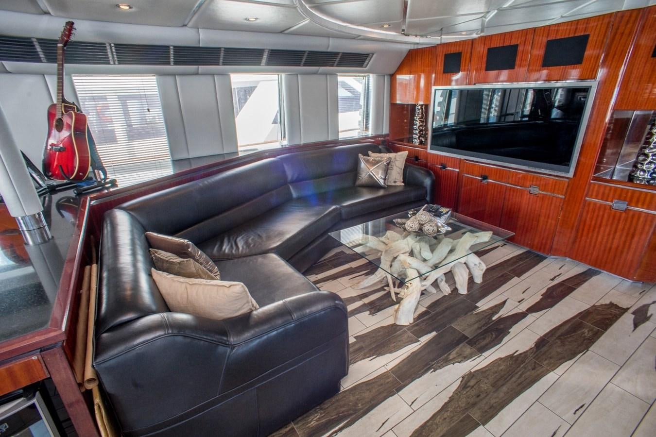 a living room with a leather couch aboard JACO Yacht for Sale