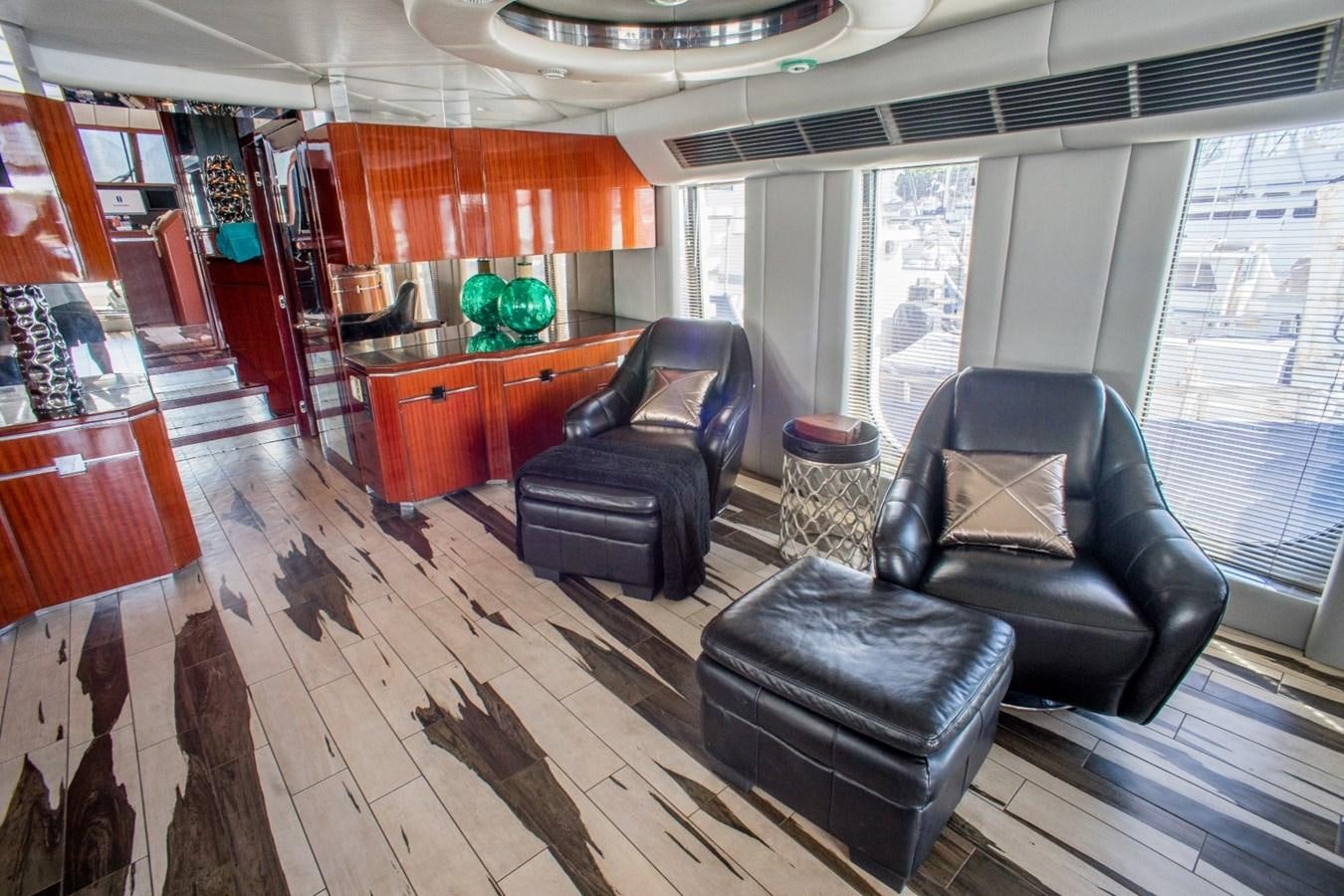 a living room with leather furniture aboard JACO Yacht for Sale