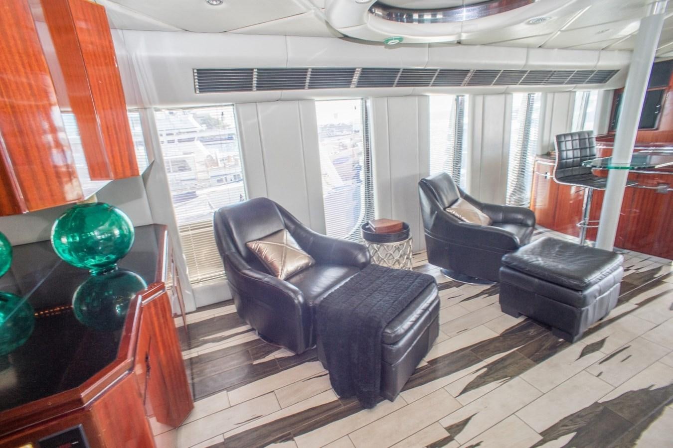 a living room with leather furniture aboard JACO Yacht for Sale