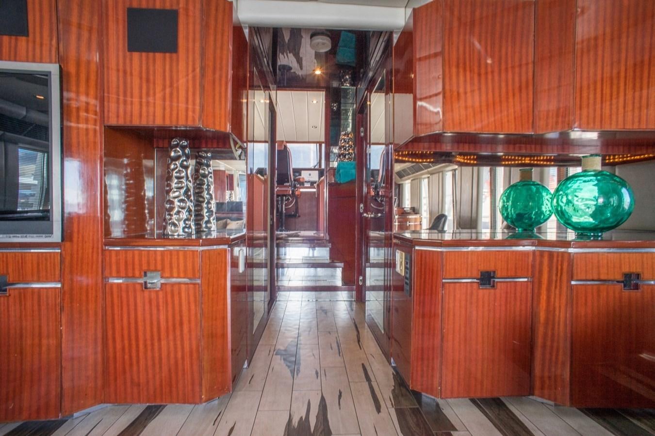 a kitchen with wooden cabinets aboard JACO Yacht for Sale