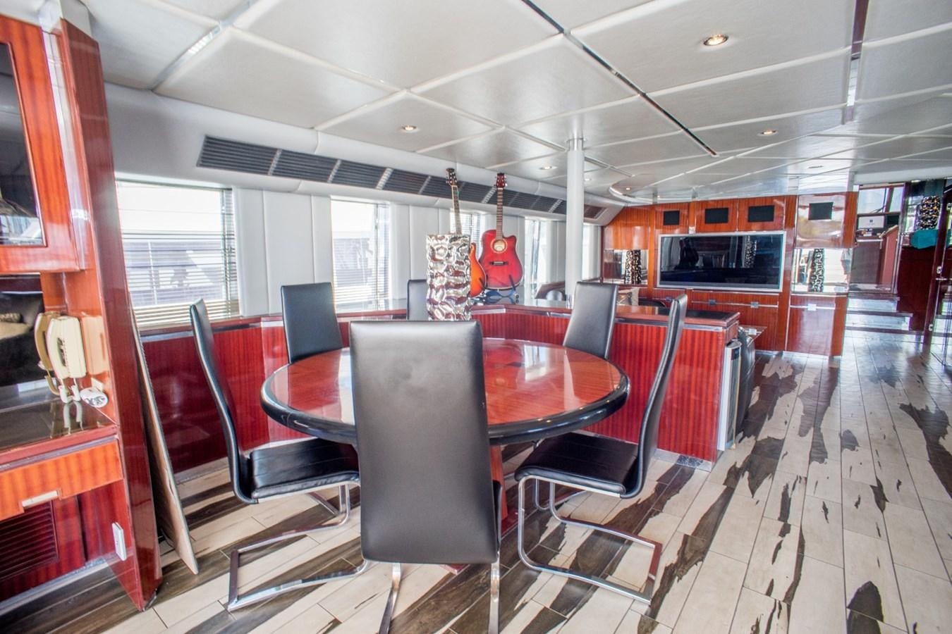 a room with a table and chairs aboard JACO Yacht for Sale