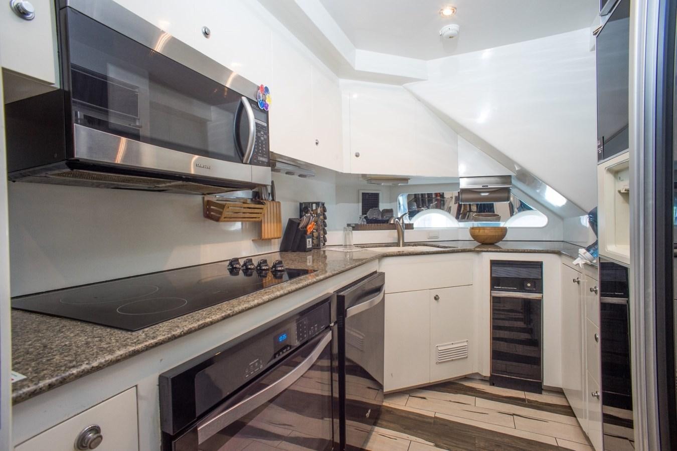 a kitchen with white cabinets aboard JACO Yacht for Sale