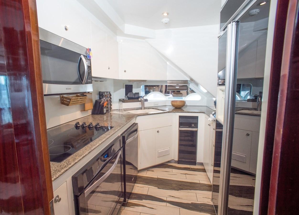 a kitchen with a sink and microwave aboard JACO Yacht for Sale
