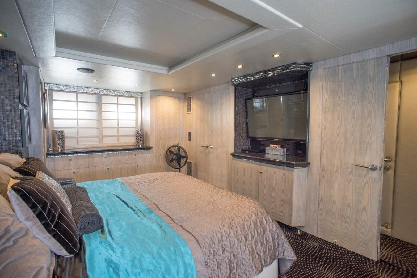 a bedroom with a bed and a television aboard JACO Yacht for Sale