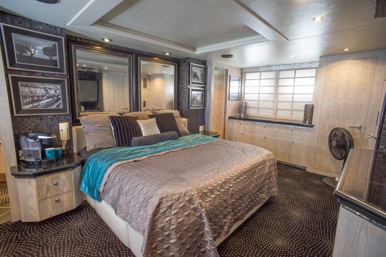 a bedroom with a bed and a window aboard JACO Yacht for Sale