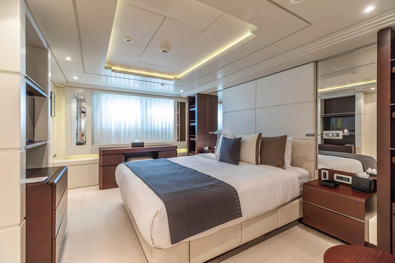 a bedroom with a bed and a desk aboard ROLA Yacht for Sale