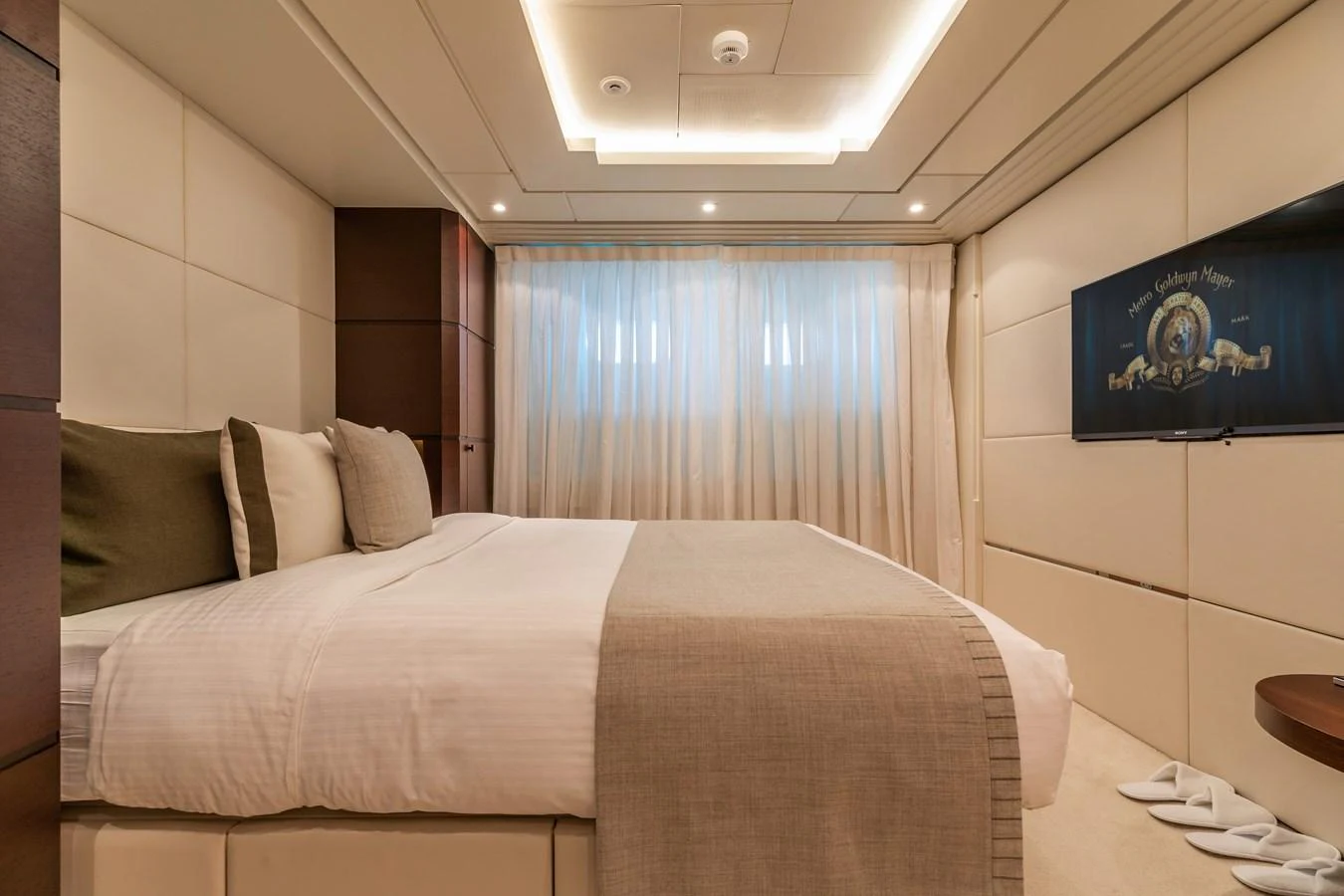 a bed with a white bed spread aboard ROLA Yacht for Sale