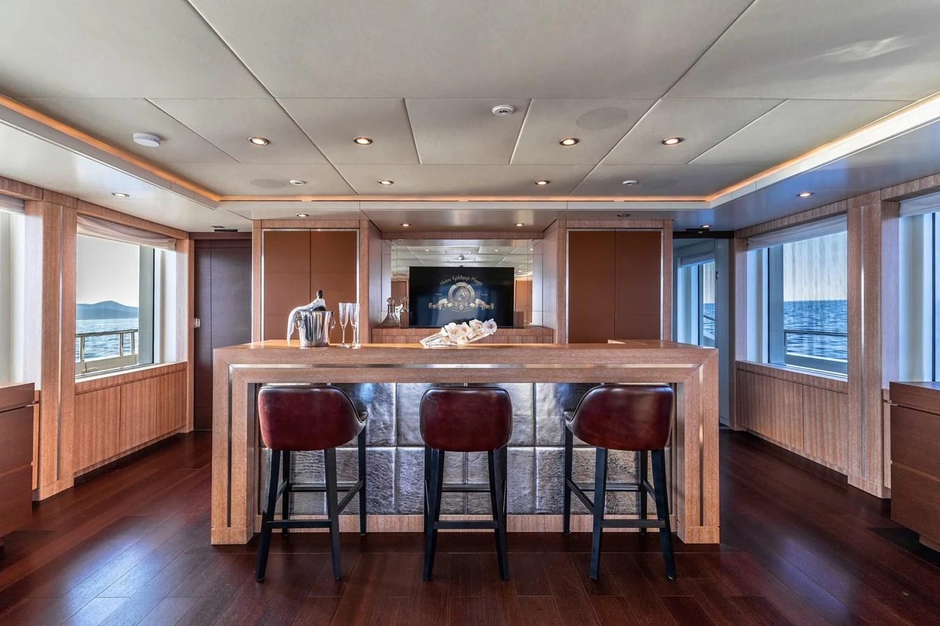 a kitchen with stools and a bar stools aboard ROLA Yacht for Sale