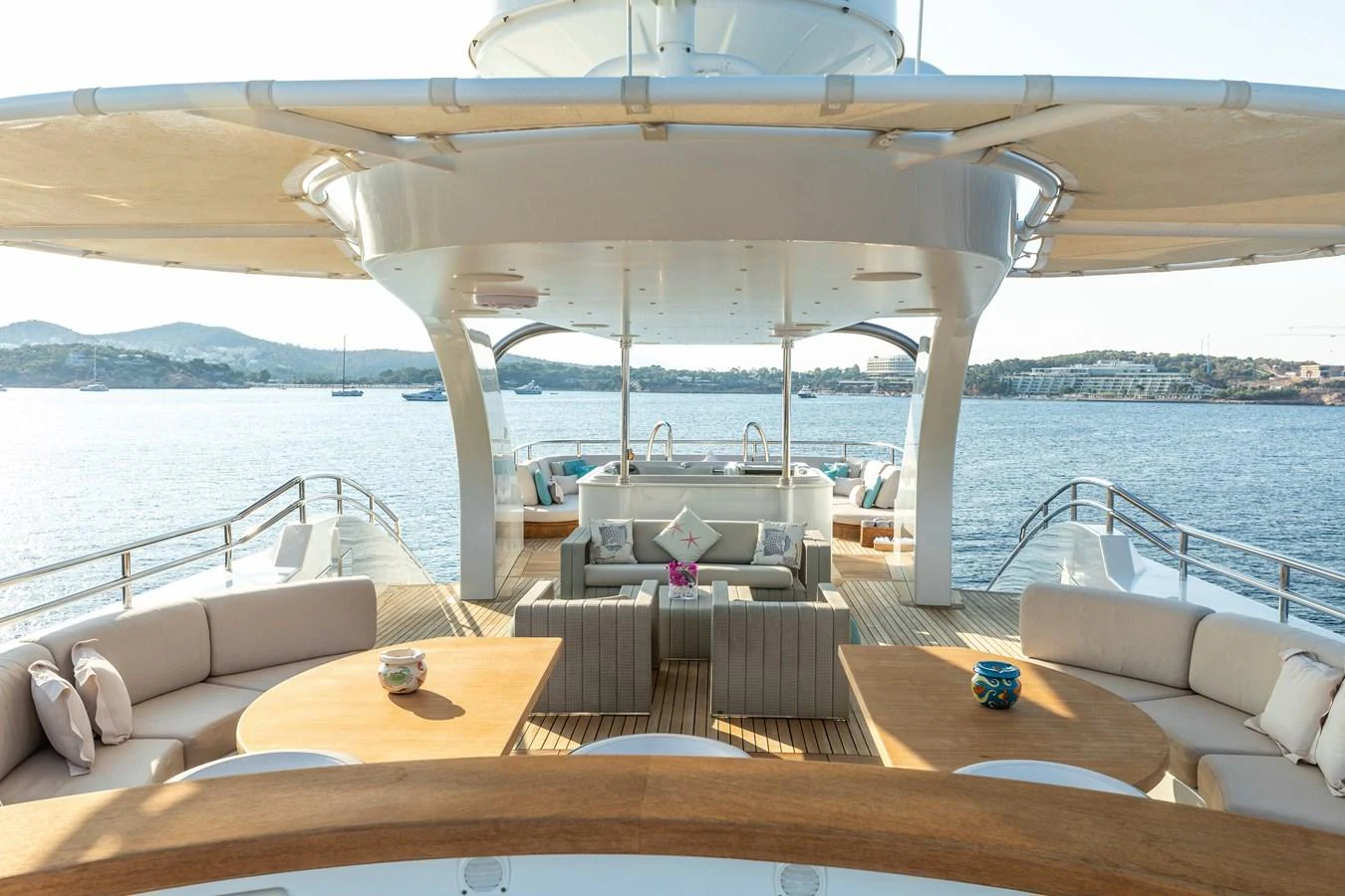 a room with a couch and a table and a view of the water aboard ROLA Yacht for Sale