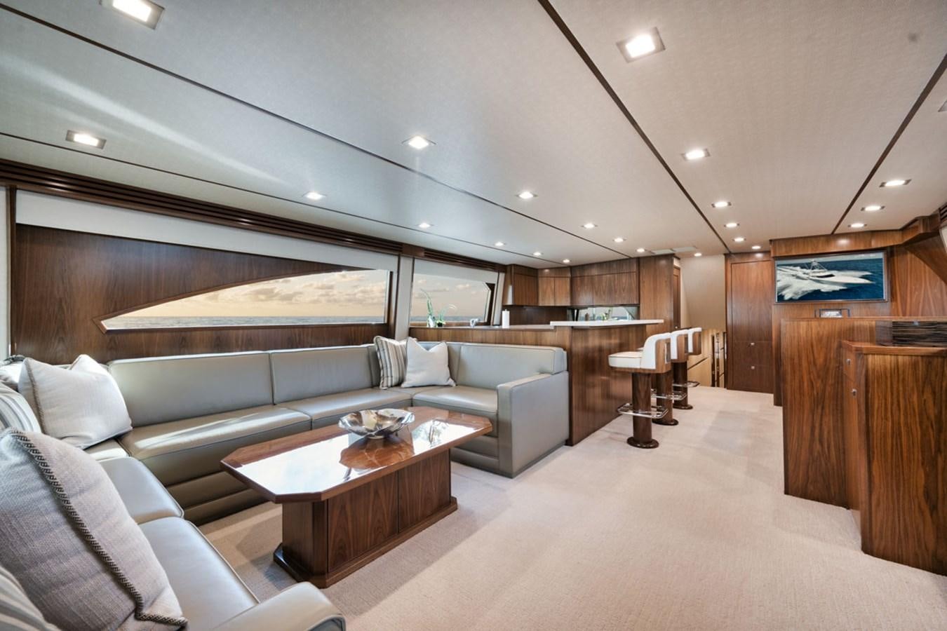 a living room with a large sofa aboard MVP Yacht for Sale