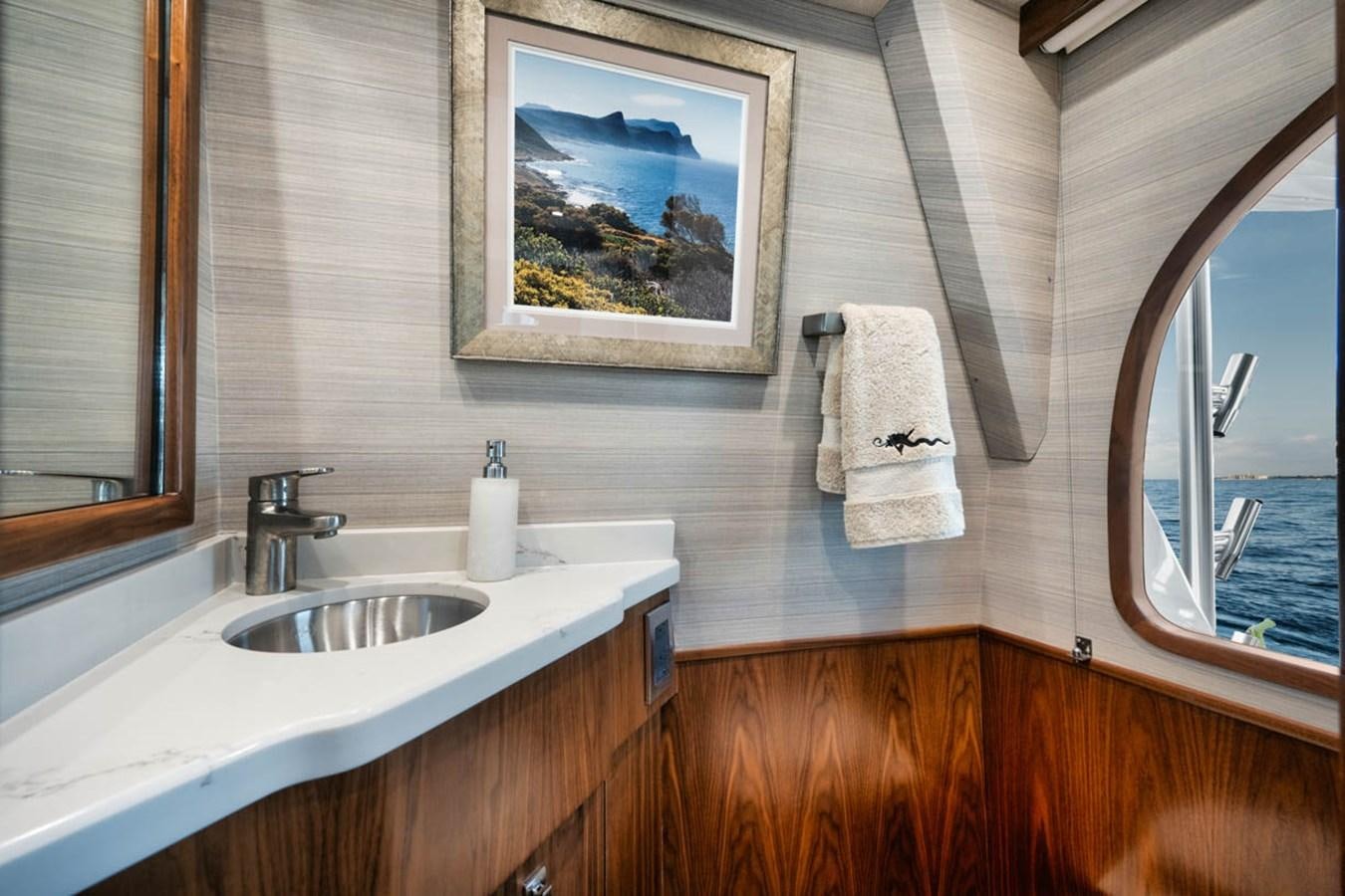 a bathroom with a sink and a mirror aboard MVP Yacht for Sale