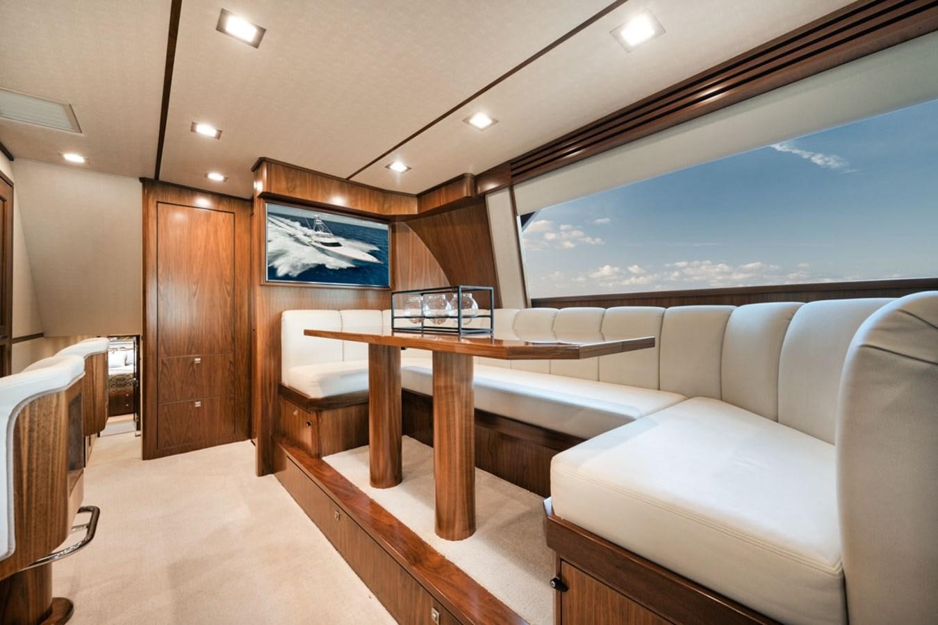 a room with a couch and a table aboard MVP Yacht for Sale