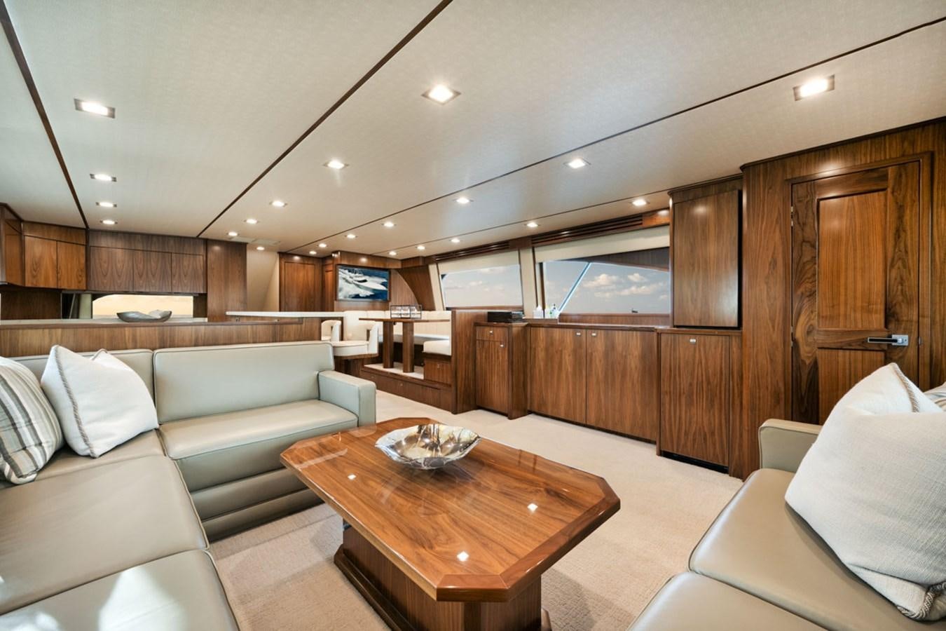 a living room with a wood table aboard MVP Yacht for Sale