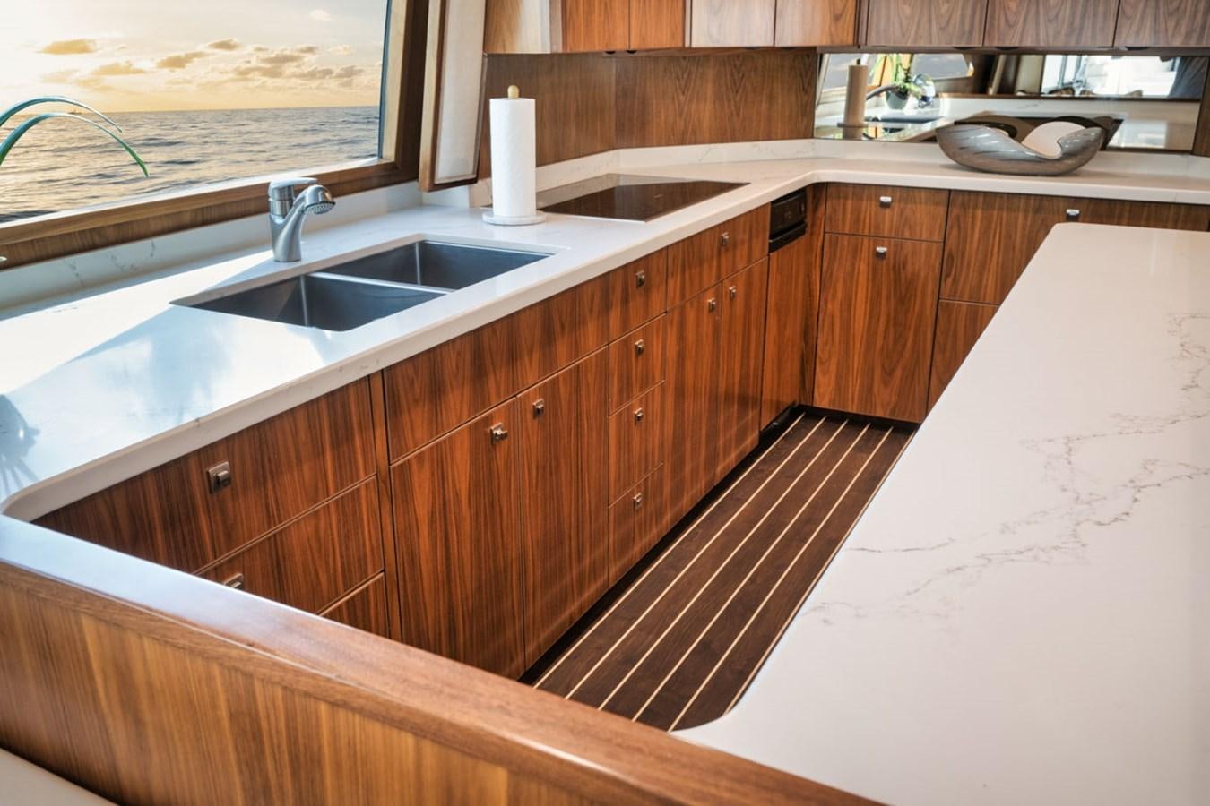 a kitchen with wooden cabinets aboard MVP Yacht for Sale