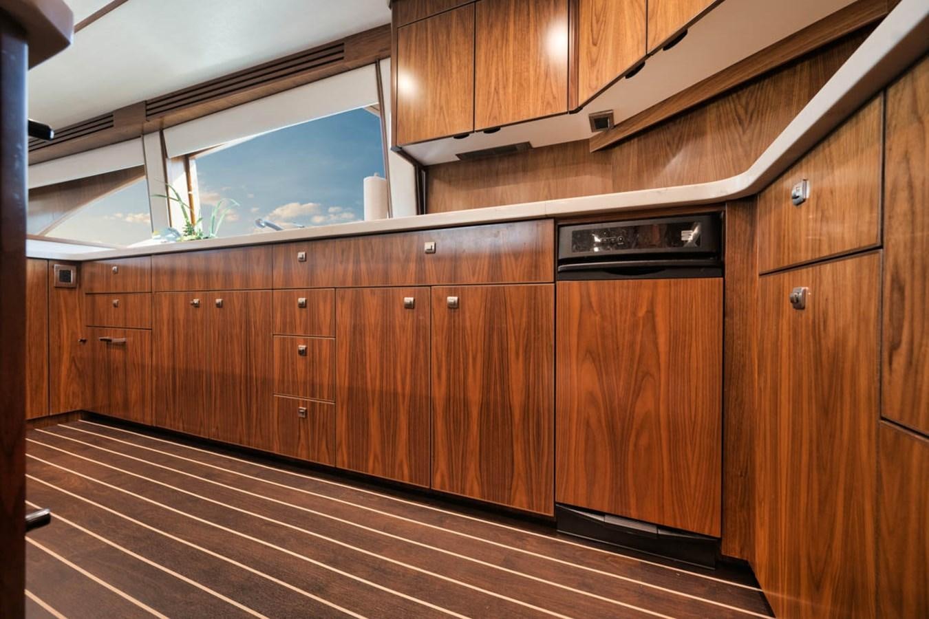 a kitchen with wooden cabinets aboard MVP Yacht for Sale
