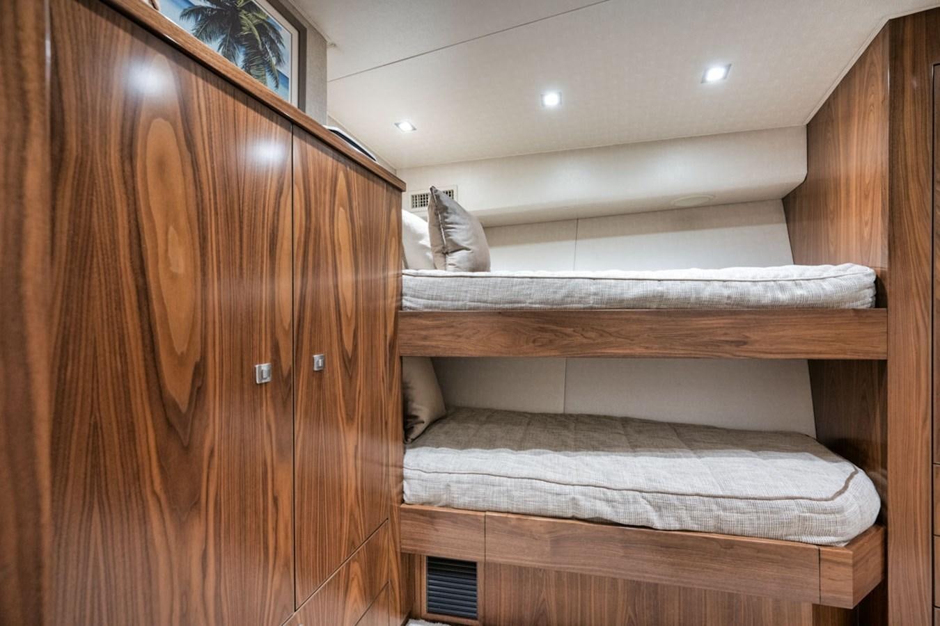 a cat lying on a wooden shelf aboard MVP Yacht for Sale