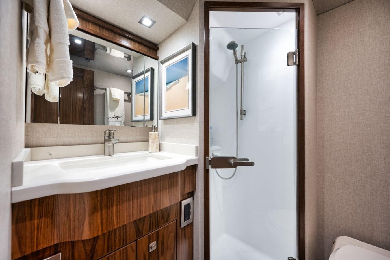 a bathroom with a sink and a mirror aboard MVP Yacht for Sale