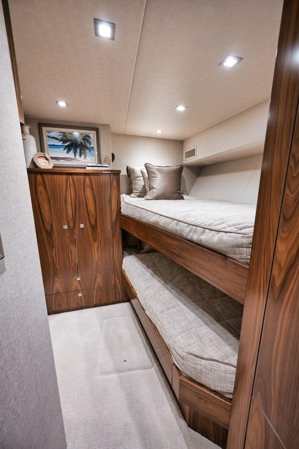 a bedroom with a bed and a television aboard MVP Yacht for Sale