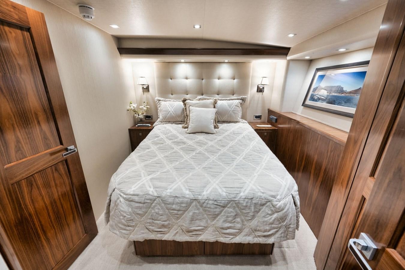 a bed with white sheets aboard MVP Yacht for Sale