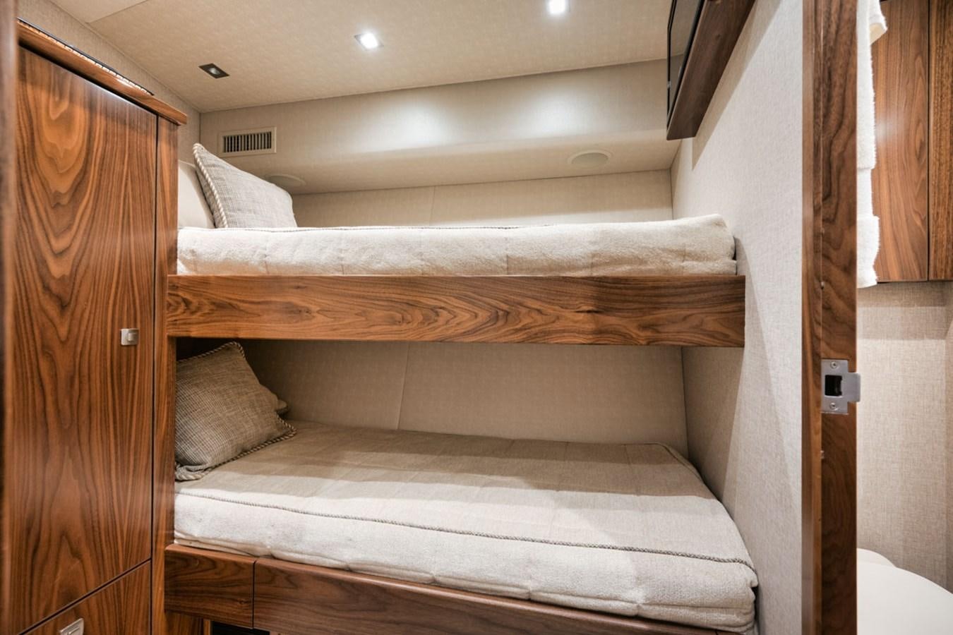 a bed with white sheets aboard MVP Yacht for Sale