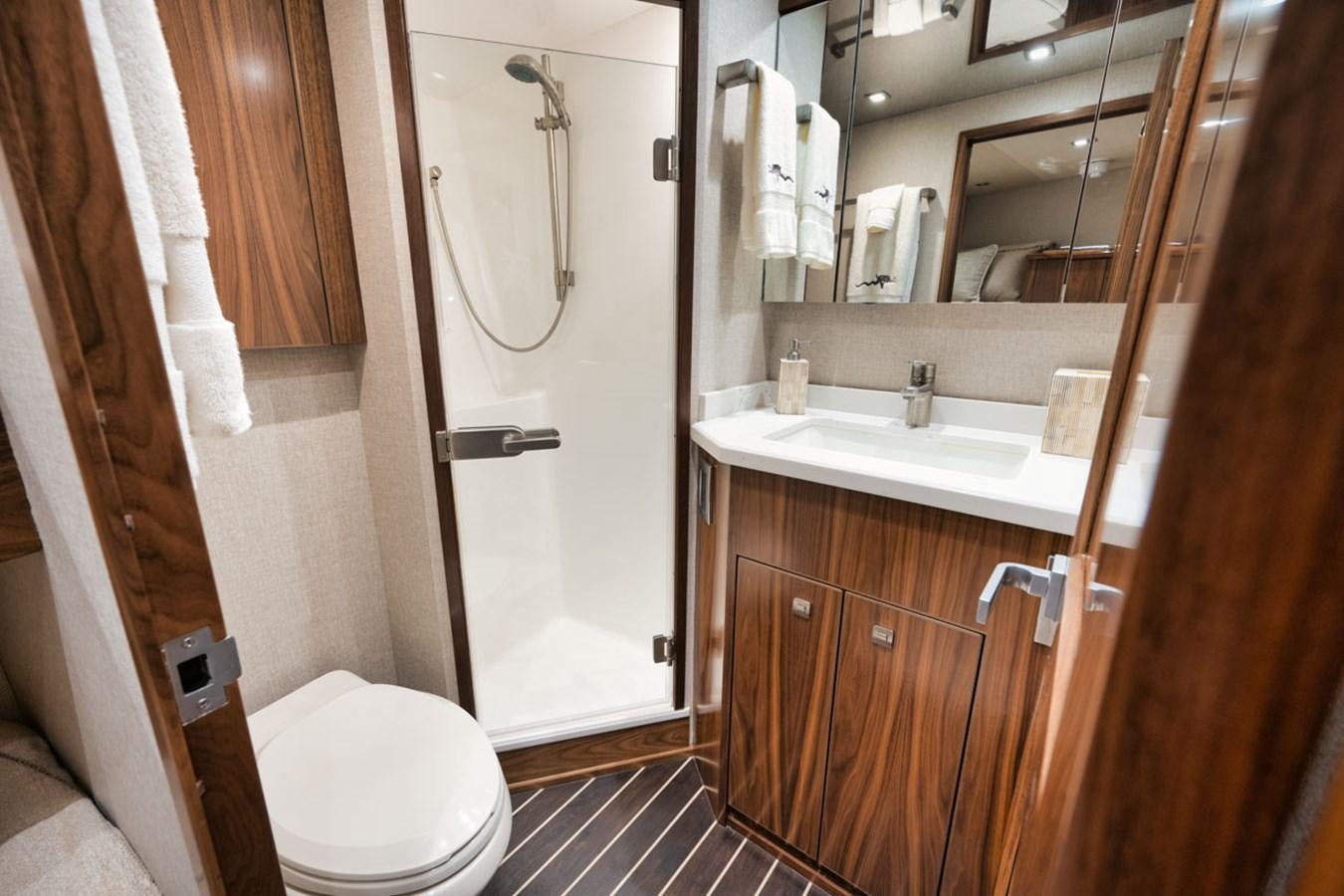 a bathroom with a toilet and sink aboard MVP Yacht for Sale