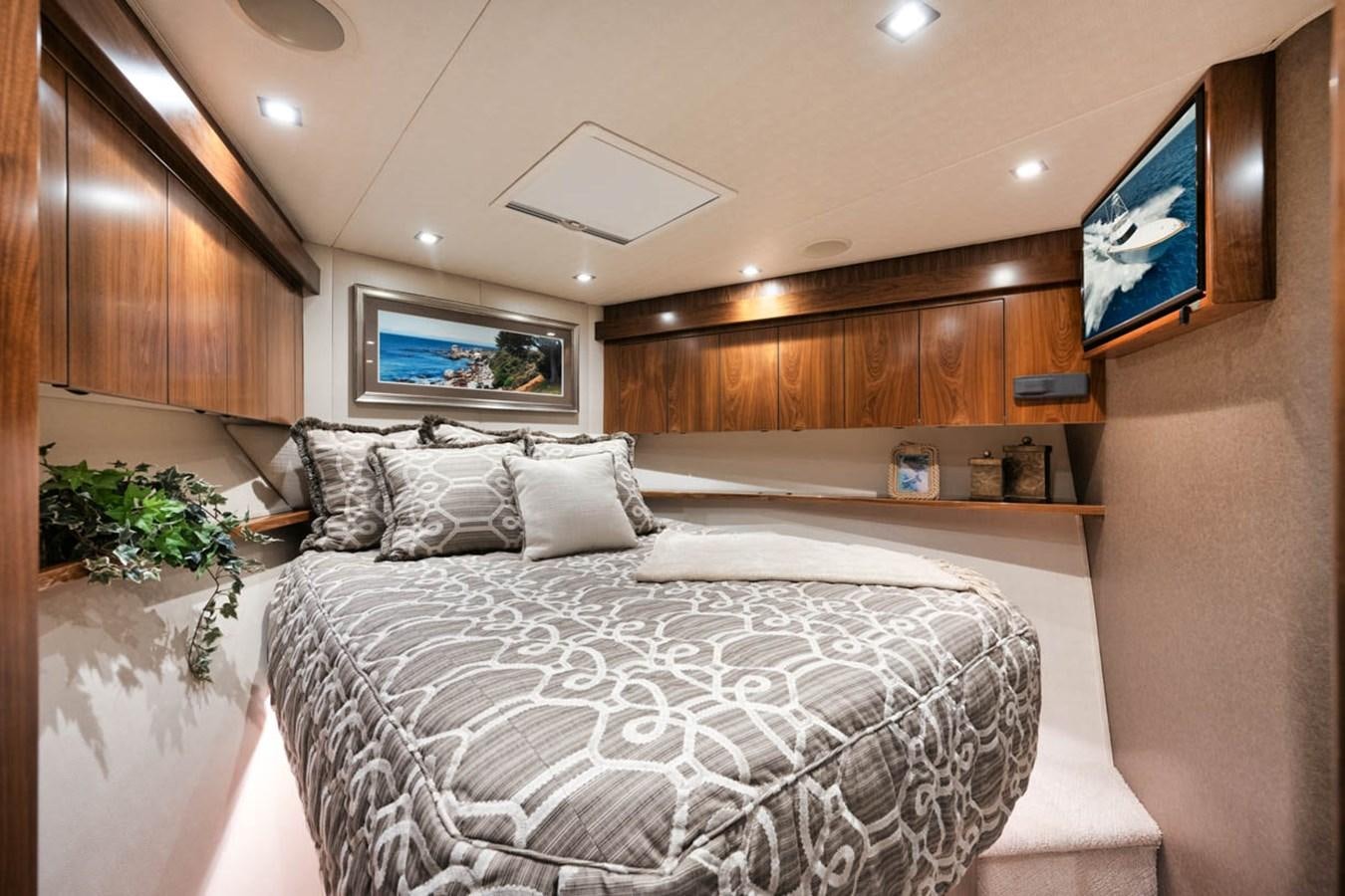 a room with a bed and a tv on the wall aboard MVP Yacht for Sale