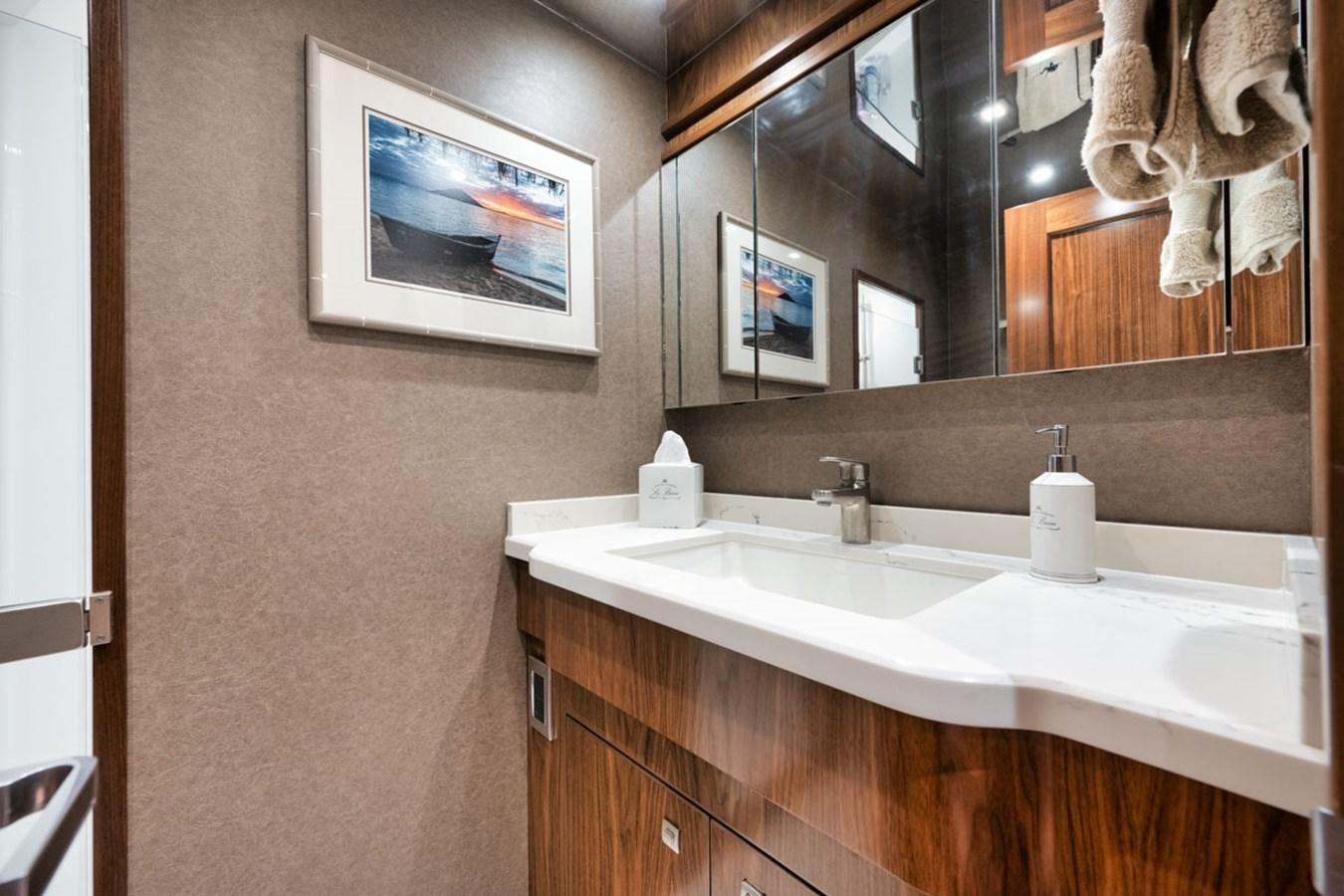 a bathroom with a large mirror aboard MVP Yacht for Sale