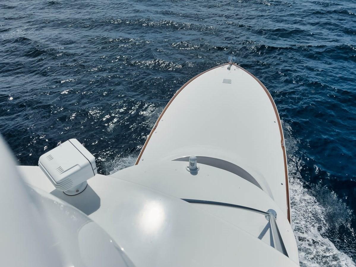 a white and black ship's nose and nose on a body of water aboard MVP Yacht for Sale