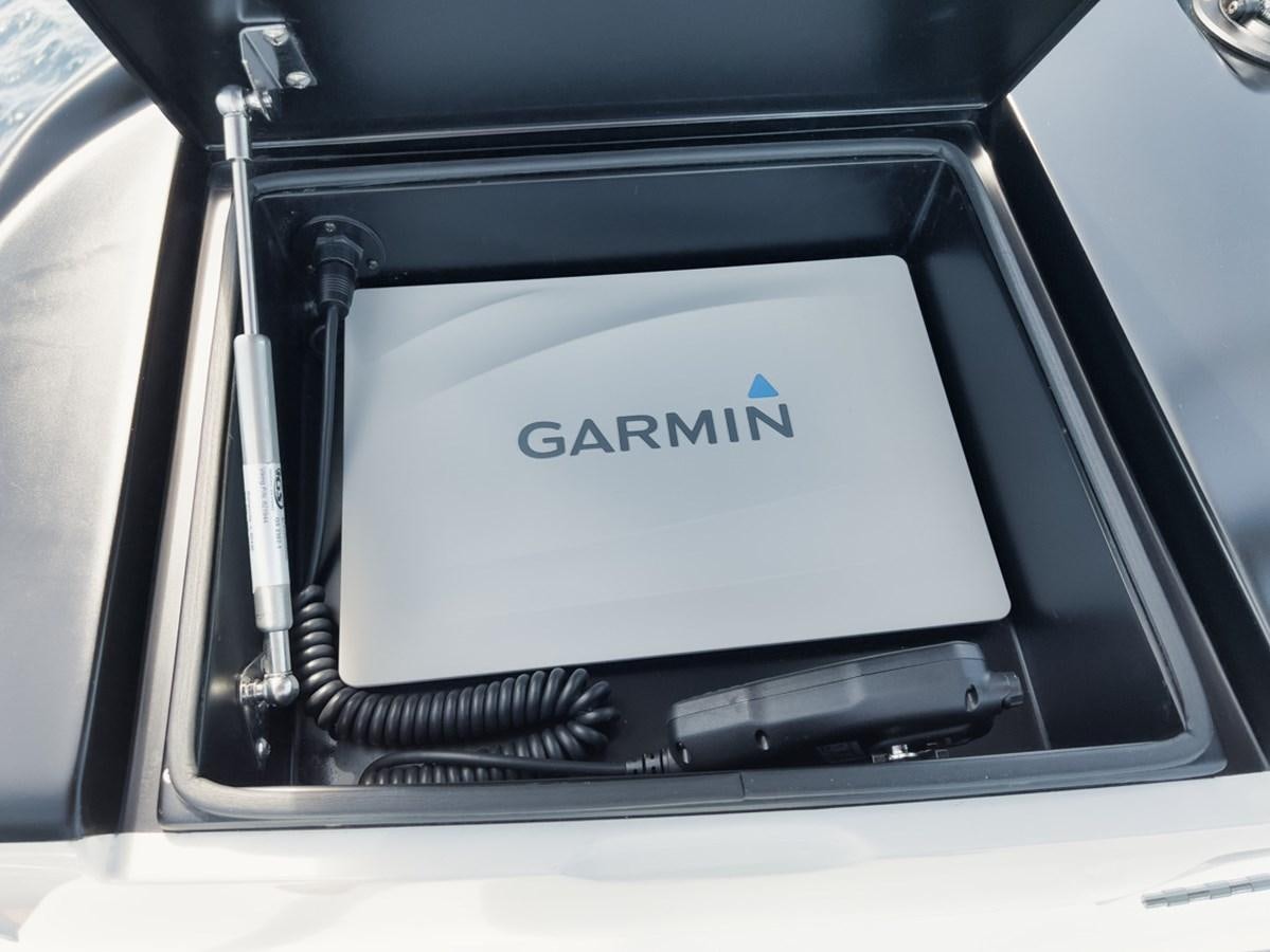 a black car with a white plate aboard MVP Yacht for Sale