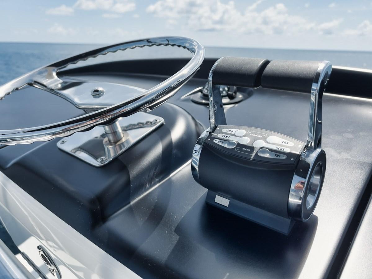 a black car steering wheel and steering wheel on a sunny day aboard MVP Yacht for Sale