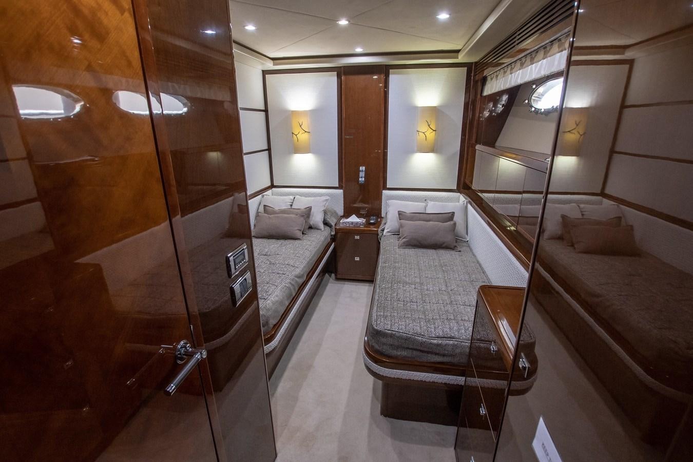 a room with a bed and a mirror aboard ROSSO Yacht for Sale